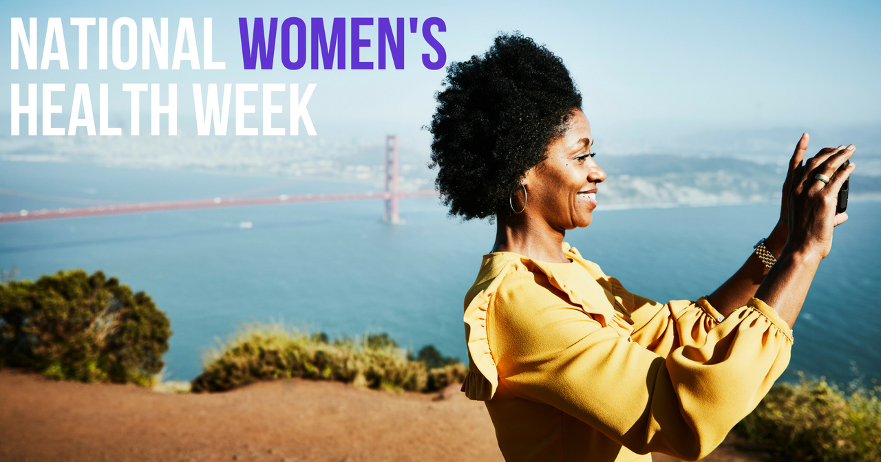 A woman takes a selfie at the Golden Gate Bridge with the words, "National Women's Health Week" behind her