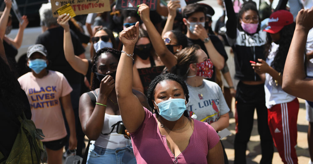 An image of protesters with signs that read, "Black Lives Matter."