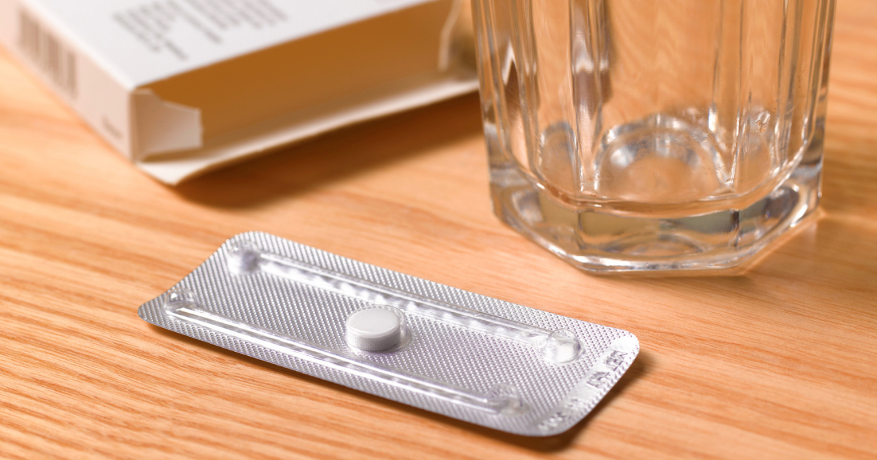 An image of an emergency contraceptive pill and a glass of water. 