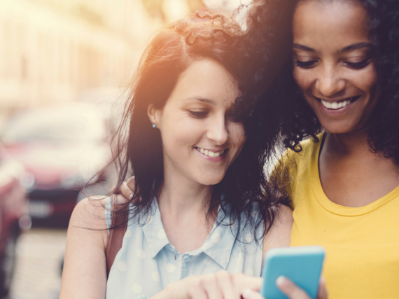 Two friends looking at a phone