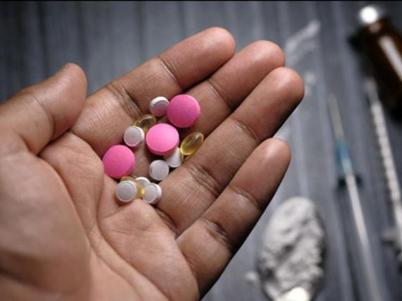 A hand with a lot of pills in the palm