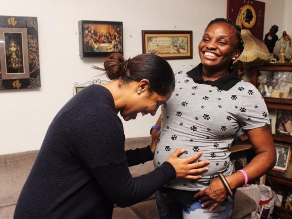 A provider and patient of Mamatoto Village laugh together. 