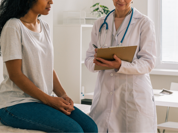 Doctor asking patient questions in her office.